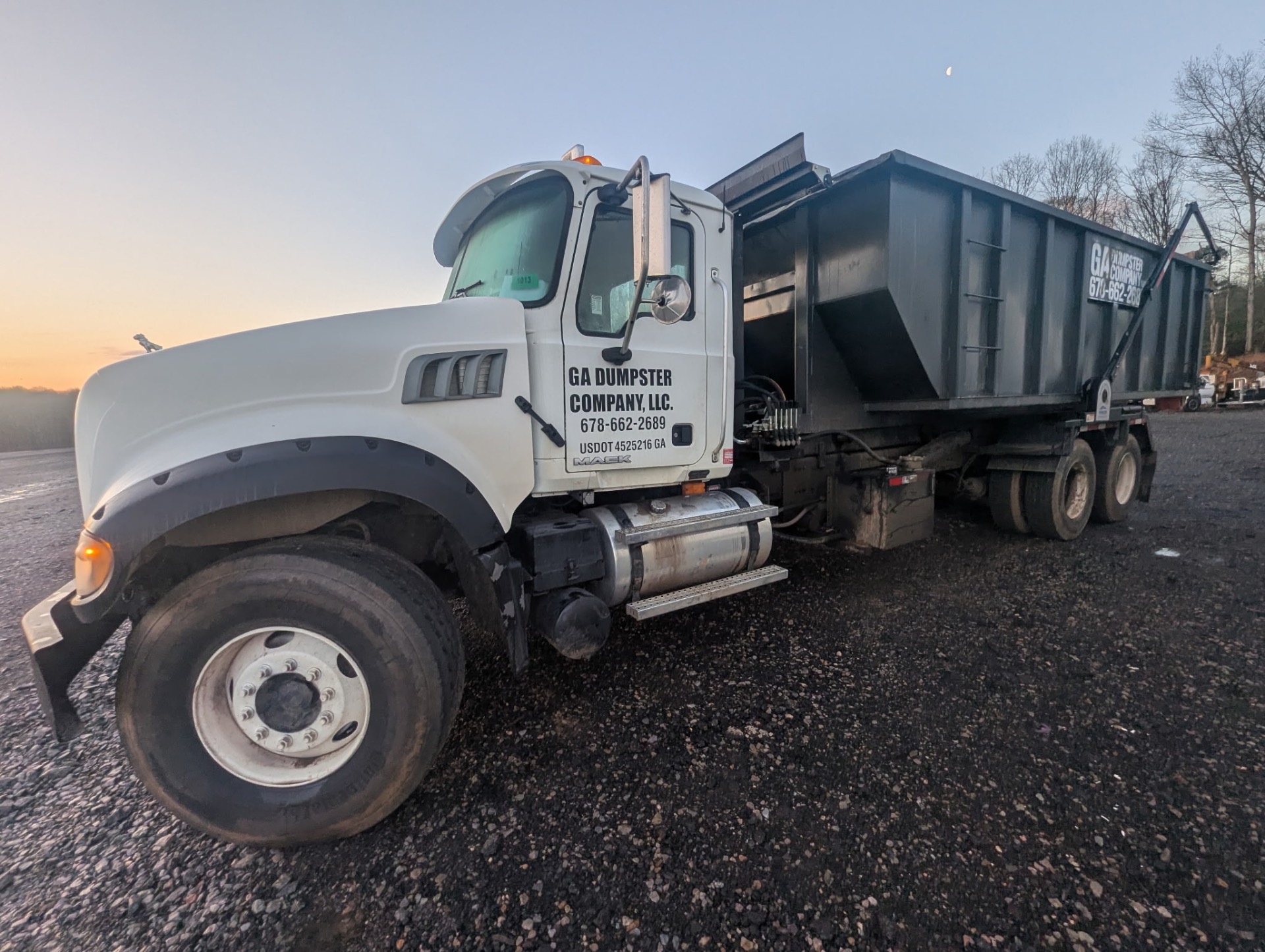 GA Dumpster Company truck at sunset
